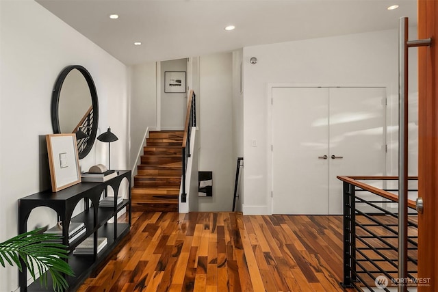 foyer with hardwood / wood-style flooring, stairs, and recessed lighting