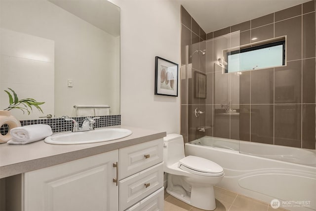 bathroom featuring toilet, shower / bathtub combination, vanity, tile patterned flooring, and backsplash