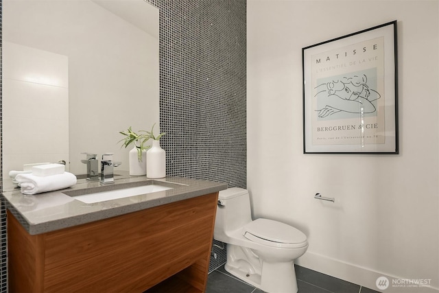 bathroom featuring toilet, tile patterned flooring, and vanity