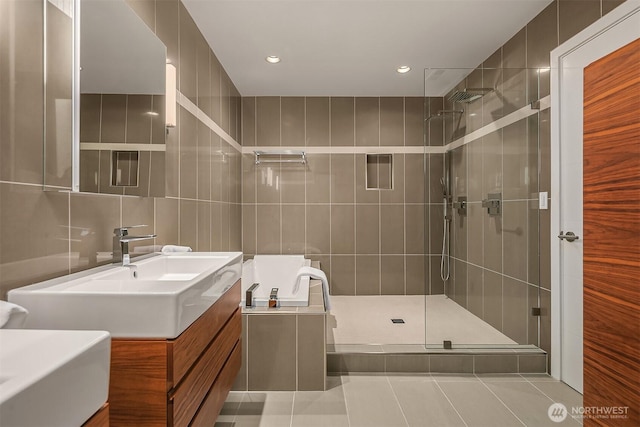 full bathroom with tile walls, vanity, recessed lighting, tile patterned flooring, and a tile shower