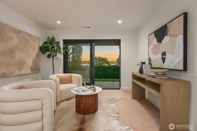 sitting room featuring carpet flooring, visible vents, baseboards, and recessed lighting