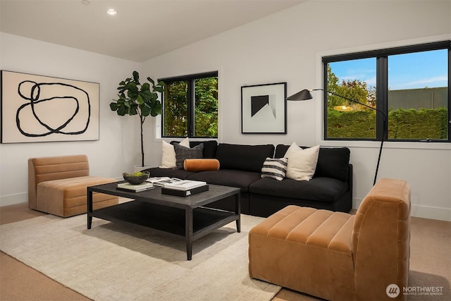 living area featuring baseboards, light carpet, recessed lighting, and lofted ceiling