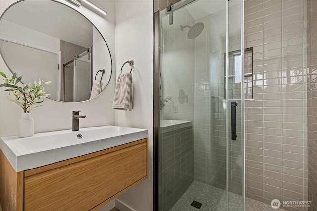 full bath featuring vanity and a shower stall