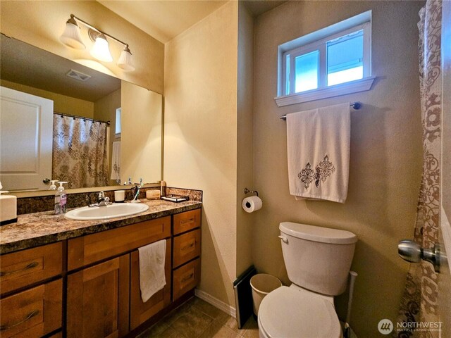 9011 Waverly Dr SW, Lakewood, WA 98499 - bathroom featuring tile patterned flooring, toilet, vanity, and baseboards