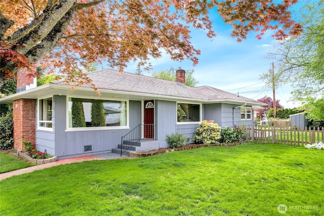ranch-style home with fence, a chimney, and a front lawn