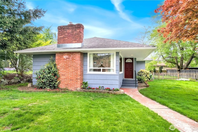 bungalow-style house featuring fence, a chimney, a shingled roof, and a front lawn