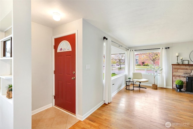entryway featuring baseboards and light wood-style flooring
