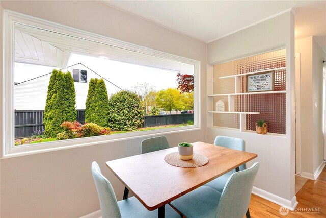 dining area featuring baseboards and wood finished floors