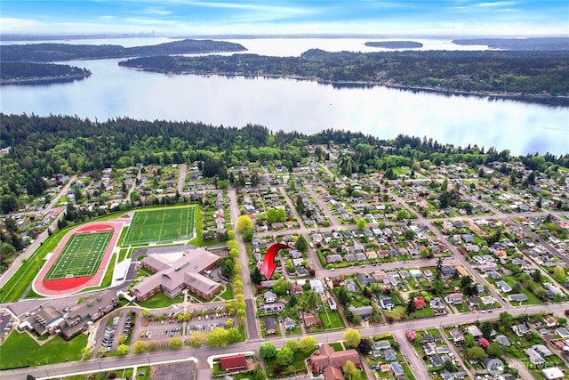drone / aerial view featuring a view of trees and a water view