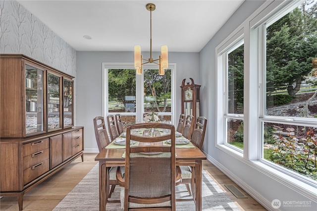 dining area featuring healthy amount of natural light and light wood-style floors