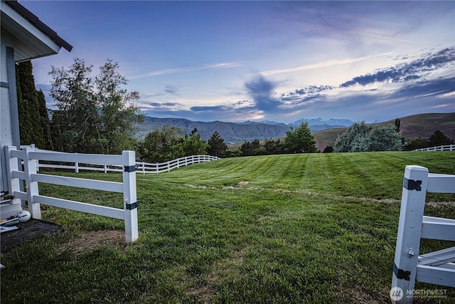 view of yard with a mountain view and a rural view