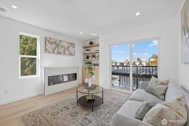 6032 42nd Ave SW Unit A, Seattle, WA 98136 - living room featuring baseboards, a glass covered fireplace, recessed lighting, and wood finished floors
