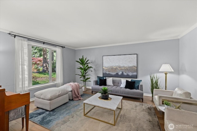 living room with crown molding, wood finished floors, and baseboards