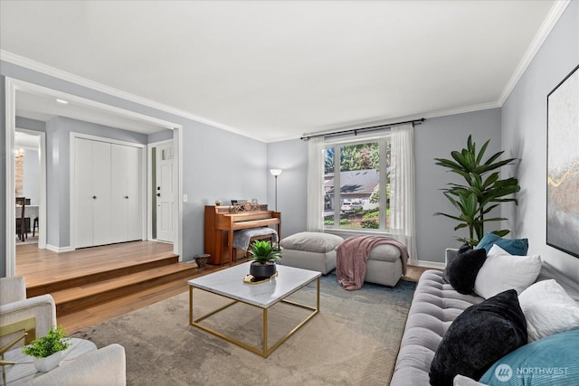 living area with wood finished floors, ornamental molding, and baseboards