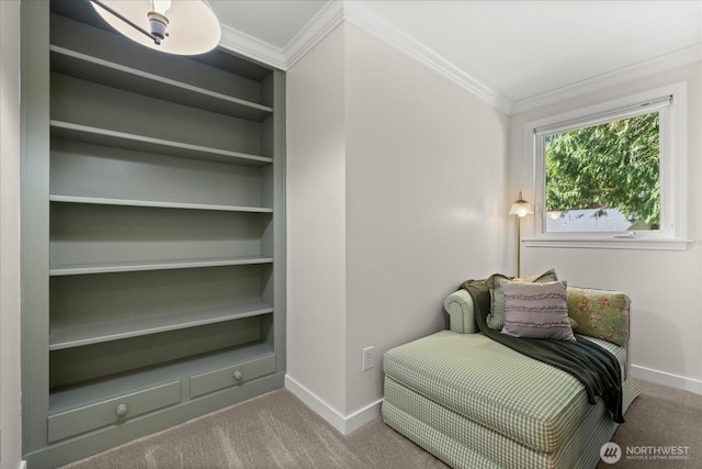 sitting room with baseboards, carpet, ornamental molding, and built in features