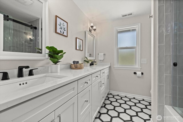 bathroom featuring a shower, double vanity, and baseboards
