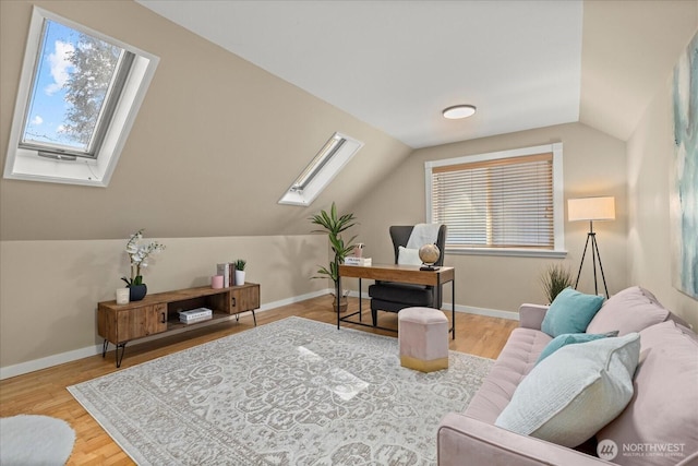 office space with a skylight, lofted ceiling, wood finished floors, and baseboards