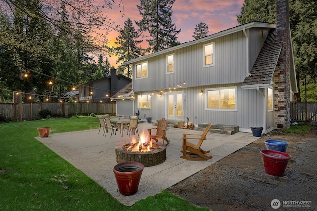 back of property featuring an outdoor fire pit, a patio, french doors, and a chimney