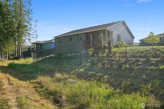 rear view of property featuring fence