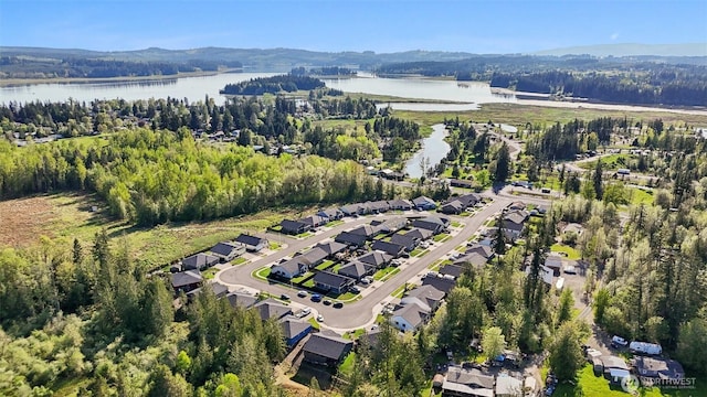 bird's eye view featuring a residential view, a water view, and a forest view
