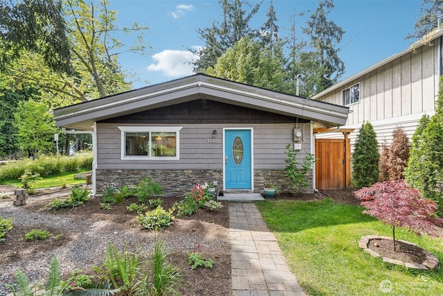 13503 Densmore Ave N, Seattle, WA 98133 - view of front of property featuring stone siding and a front lawn