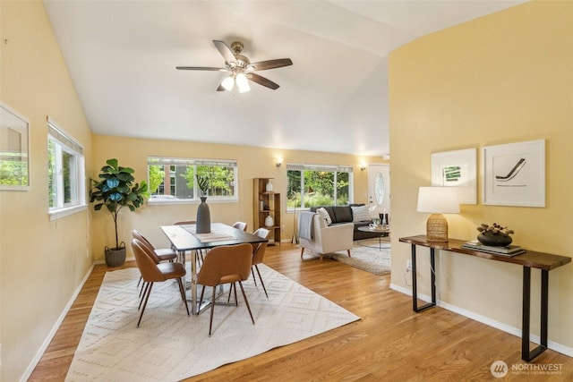 13503 Densmore Ave N, Seattle, WA 98133 - dining room with ceiling fan, wood finished floors, high vaulted ceiling, and baseboards