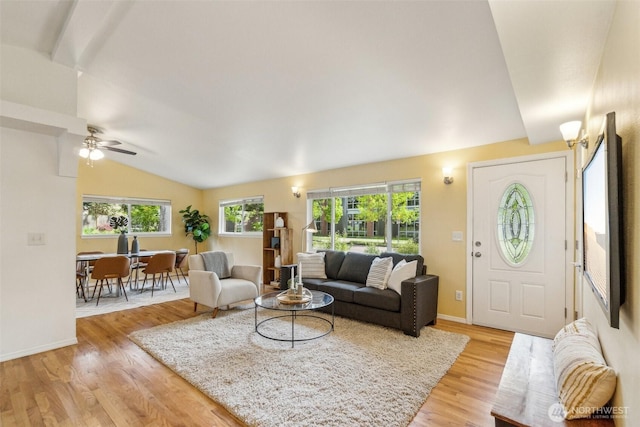 13503 Densmore Ave N, Seattle, WA 98133 - living area with vaulted ceiling, light wood-style flooring, ceiling fan, and baseboards