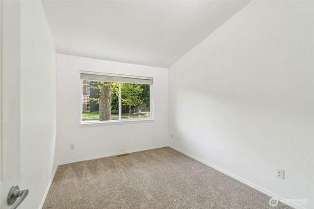13503 Densmore Ave N, Seattle, WA 98133 - carpeted empty room featuring lofted ceiling and baseboards