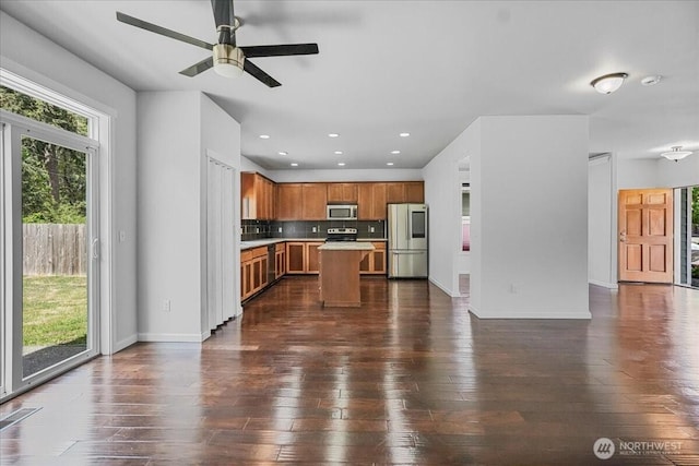kitchen with stainless steel appliances, healthy amount of natural light, open floor plan, light countertops, and recessed lighting