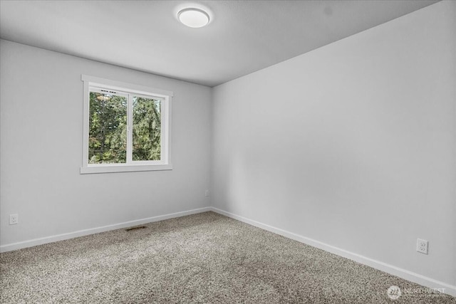 carpeted empty room with baseboards