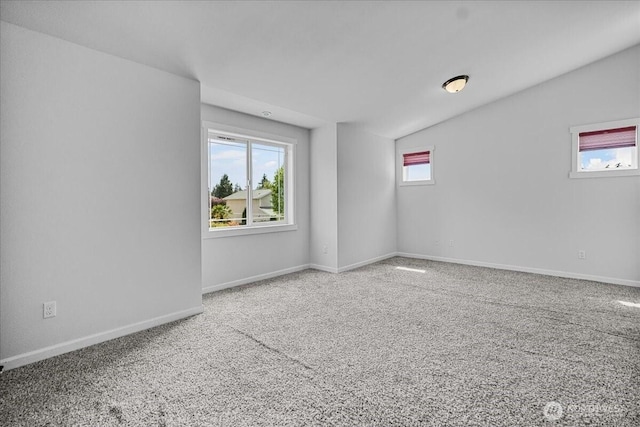 spare room featuring carpet flooring and baseboards