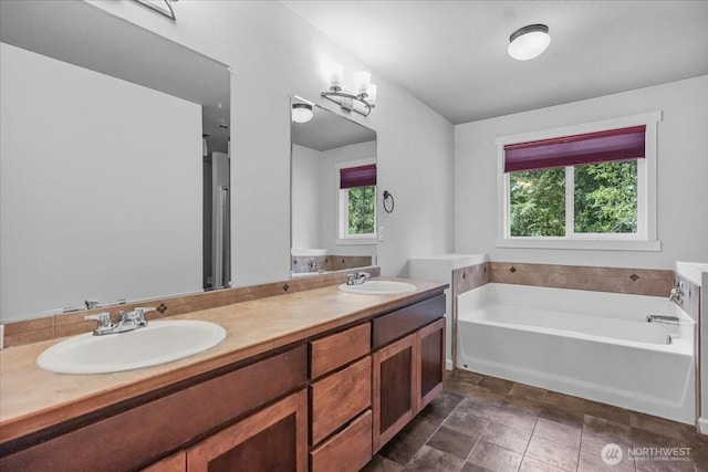 full bath featuring a bath and double vanity