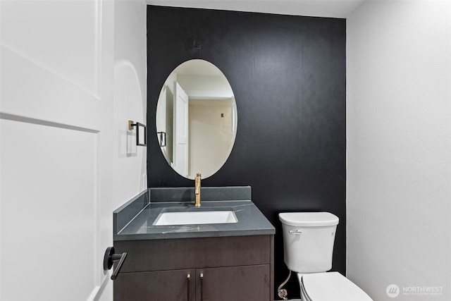 half bathroom with vanity and toilet