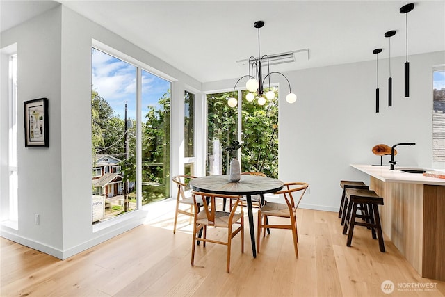627A W Emerson St, Seattle, WA 98119 - dining space featuring baseboards, a wealth of natural light, and light wood-style flooring
