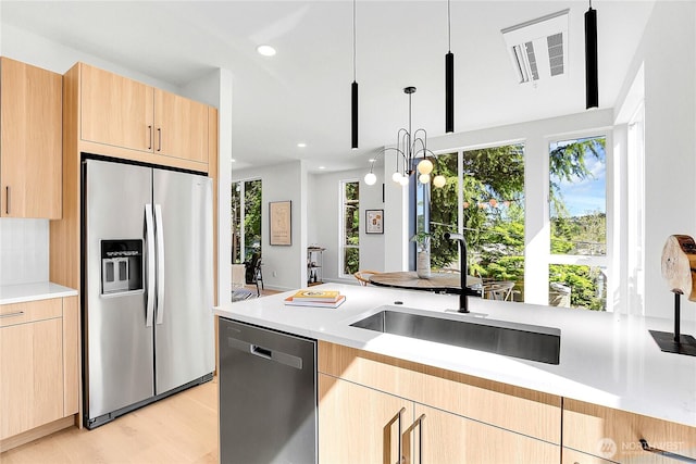 627A W Emerson St, Seattle, WA 98119 - kitchen with a sink, appliances with stainless steel finishes, light brown cabinetry, and light countertops