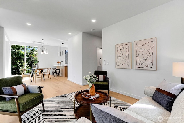 627A W Emerson St, Seattle, WA 98119 - living area with recessed lighting, baseboards, a notable chandelier, and light wood-style floors