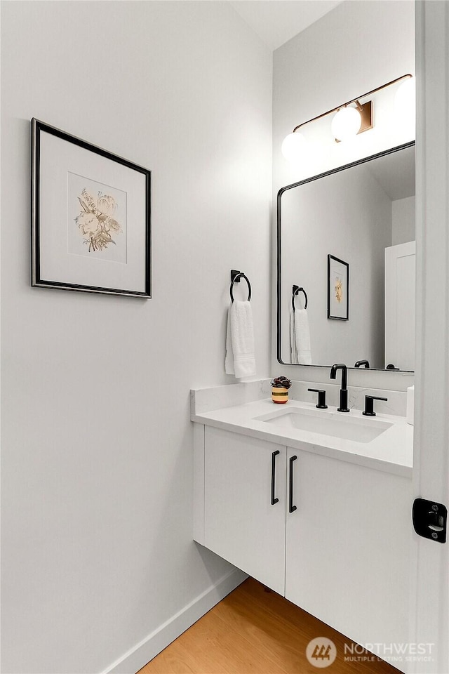 627A W Emerson St, Seattle, WA 98119 - bathroom featuring baseboards, wood finished floors, and vanity