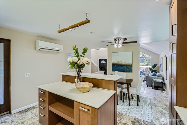 22606 NE 14th Dr, Sammamish, WA 98074 - kitchen featuring light countertops, a center island, a wall mounted air conditioner, and stone tile floors