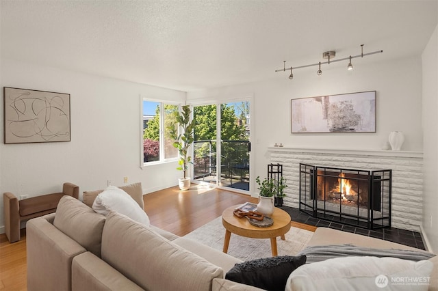 1751 NW 58th St Unit 4, Seattle, WA 98107 - living area with a fireplace with flush hearth, baseboards, and wood finished floors