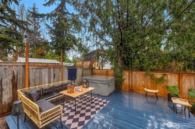 deck with a fenced backyard, an outdoor hangout area, and a hot tub