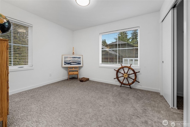 unfurnished bedroom featuring a closet, carpet, and baseboards