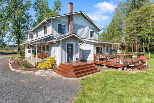 584 Gish Rd, Onalaska, WA 98570 - rear view of property with a chimney, a yard, and a porch