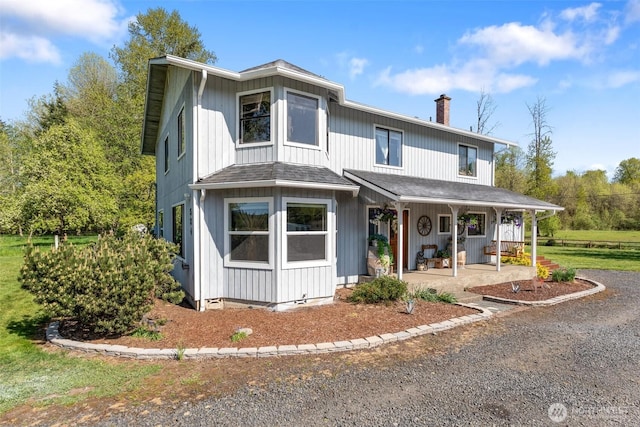 584 Gish Rd, Onalaska, WA 98570 - traditional-style home with covered porch, a chimney, and a shingled roof