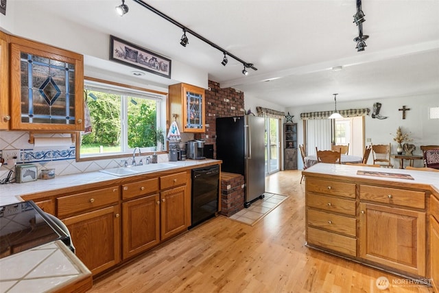 584 Gish Rd, Onalaska, WA 98570 - kitchen with tile counters, freestanding refrigerator, rail lighting, and dishwasher