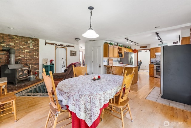 584 Gish Rd, Onalaska, WA 98570 - dining space with a wood stove and light wood-type flooring