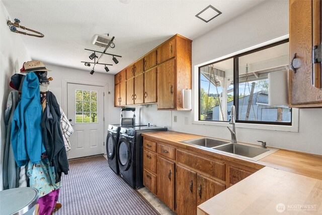584 Gish Rd, Onalaska, WA 98570 - washroom featuring washing machine and clothes dryer, a sink, and cabinet space