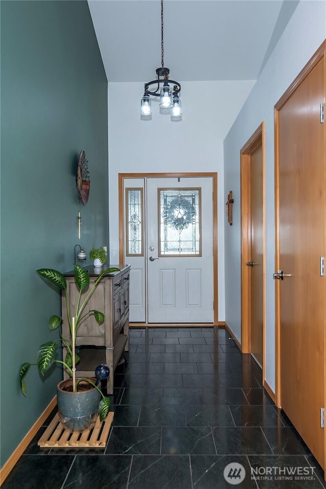 foyer entrance featuring baseboards