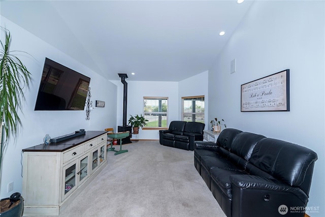 living area with lofted ceiling, recessed lighting, and light colored carpet