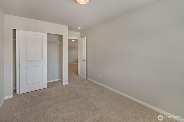 18214 37th Ave E, Tacoma, WA 98446 - unfurnished bedroom featuring baseboards, light colored carpet, and a closet