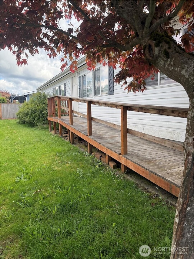 view of yard with a deck and fence